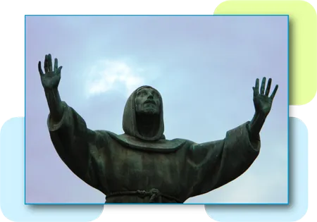 A worm's eye view of a statue of Jesus Christ with his arms spread apart towards the sky
